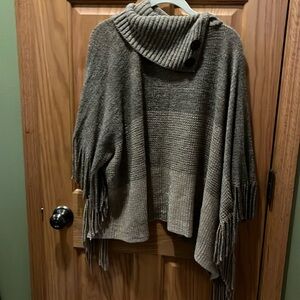 Poncho  sweater with arm holes slight metallic, threading through the knitting.